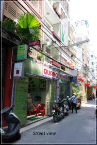 a street view of a building with signs on it at QUANG SAIGON Hotel- 40-7 Bùi Viện-Walking street in Ho Chi Minh City