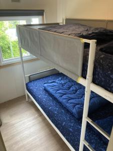 a bunk bed in a room with a window at KD 883 - Vakantiepark Kijkduin in The Hague