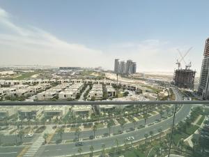 arial view of a city with buildings and a highway at Tranquil Studio in Damac Hills in Dubai