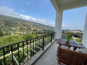 a balcony with a table and a view of a valley at Afroessa apartments in Mesariá