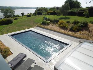 a swimming pool with a view of the water at Belle vue sur mer in Saint-Michel-en-Grève