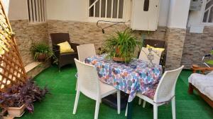 a table and chairs with plants on a patio at Apulia lux in Taranto