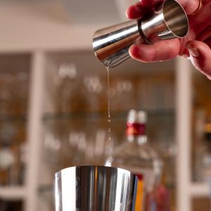 a person is pouring coffee into a cup at Hôtel Restaurant La Voile Bleue in Erdeven