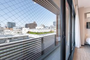 a balcony with a view of a city at Hotel Sanrriott Osaka Hommachi in Osaka