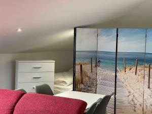 a bedroom with a bedroom with a view of the beach at Ferienhaus Quartier18 - strandnah S3 in Karlshagen