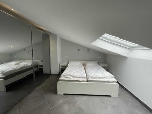 a bedroom with two beds and a skylight at Ferienhaus Quartier18 - strandnah S3 in Karlshagen