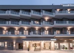 an exterior view of a building with balconies at Kos Divine Hotel & Suites in Kos