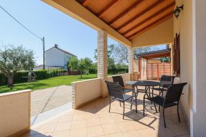a patio with a table and chairs on it at MIMA house with apartments in Savudrija