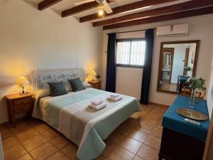 a bedroom with a bed with two towels on it at Nerja Paradise Rentals - Villa Alminares in Nerja