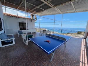 a ping pong table in a room with a view of the ocean at Nerja Paradise Rentals - Villa Alminares in Nerja