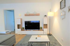 a living room with a flat screen tv on a wall at Mein Apartment, Stars mit Balkon und Klima für bis zu 4 Personen in Frankenthal