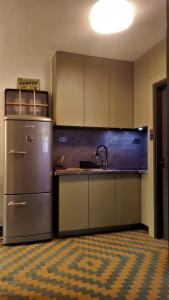 a kitchen with a stainless steel refrigerator and a sink at Retro in Tolmin