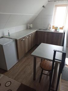 a kitchen with a table and a sink and a refrigerator at U Wyrostków in Gliczarów Górny