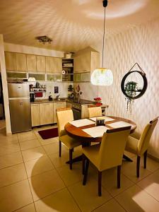 a kitchen with a wooden table and yellow chairs at Apartment "Gluecks-Griff" inside "Becici Sunset Apartments" in Budva