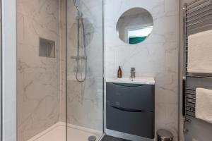 a bathroom with a shower and a sink at The Green Door in Downpatrick