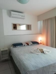a bedroom with a bed with two towels on it at Beach Class Rosalux 707 in Fortaleza +23 photos