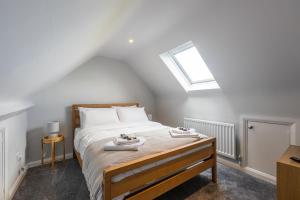 a bedroom with a bed with two towels on it at The Green Door in Downpatrick