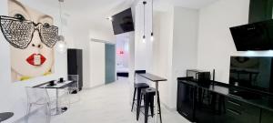 a white room with black tables and stools at Puerto Principe LOFT in Santander