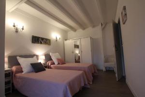 a hotel room with two beds with a laptop on them at Maison etxebarnia cote in Mendive
