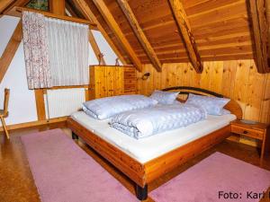 a bedroom with a bed in a wooden room at Ferienhof Kienbronnerhof in Schiltach
