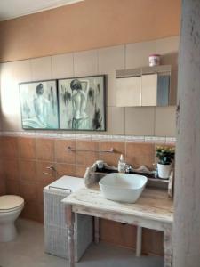 een badkamer met een wastafel en een toilet bij At Home Apartments in Mokopane