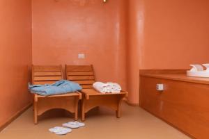 a room with a wooden bench with towels on it at Hotel America in Marina di Camerota