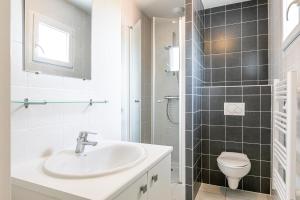 a bathroom with a sink and a toilet at Oasis Les Jardins des Sables d'Olonne in Les Sables-dʼOlonne