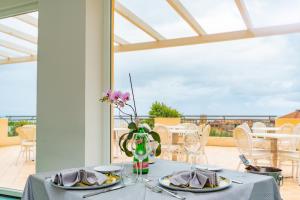a table with two plates of food on a balcony at Hotel America in Marina di Camerota