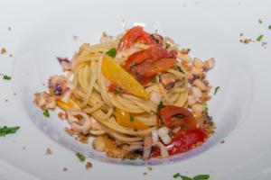 a plate of pasta with shrimp and other vegetables at Hotel America in Marina di Camerota