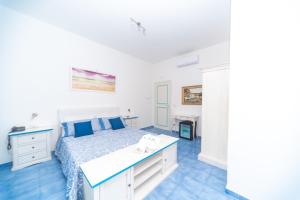 a bedroom with a bed and a desk at Hotel America in Marina di Camerota