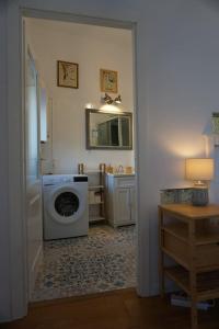 a laundry room with a washing machine and a sink at Central Park Apartment in Cluj-Napoca +6 photos