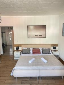a bedroom with a large bed with two pillows on it at Mavi Apartments in Dubrovnik