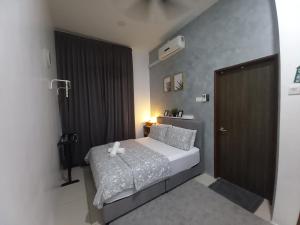 a small bedroom with a bed and a door at RS Homestay in Sungai Petani