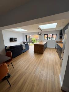 a living room with a couch and a table at 3 bed luxury open plan living in Rayleigh