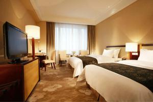 Säng eller sängar i ett rum på Tianjin Saixiang Hotel