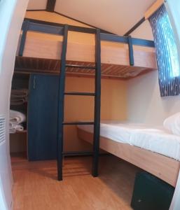 a room with two bunk beds in a dorm room at Camping Playa de Ris in Noja