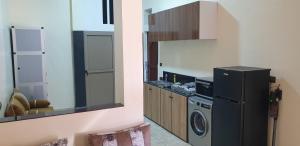 a kitchen with a refrigerator and a washing machine at APARTAMENTOS NASSIRi in Laayoune