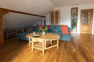 a living room with a blue couch and a table at Charming two bedrooms apartment in Sighişoara