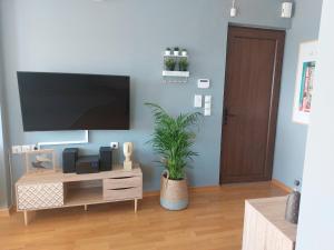 a living room with a flat screen tv on a wall at 365 Urban Suite in Heraklio