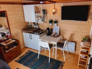 a kitchen with a table and chairs in a room at Merela guest house in Võsu centre in Võsu