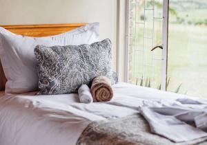 ein Bett mit zwei Handtüchern und einem Fenster in der Unterkunft Nkomazi Game Reserve by NEWMARK in Badplaas