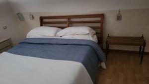 a bedroom with a large bed with white and blue sheets at Apulia lux in Taranto