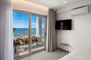 a bedroom with a view of the ocean at Milatos Seaside Suites in Milatos
