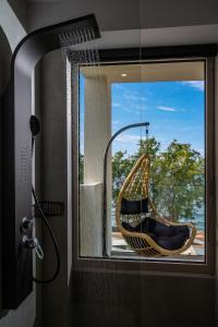 a hammock hanging from a window in a bathroom at Milatos Seaside Suites in Milatos
