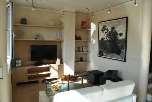 a living room with a couch and a tv at Villa Alexandria in Milna