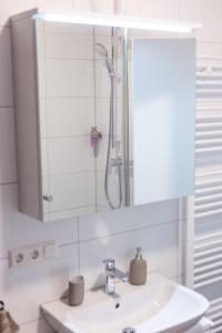 a bathroom with a sink and a shower at City-House-Achern in Achern
