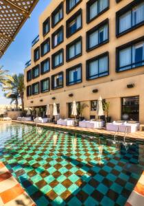 a swimming pool in front of a hotel at Brown Eilat a member of Brown Hotels in Eilat