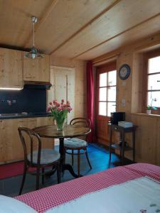 a kitchen with a table and chairs in a room at Chez Pierre in Praz-de-Fort