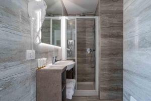 a bathroom with a sink and a shower at Maioliche Apartments Griante in Griante Cadenabbia +110 photos