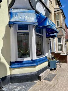 a blue and white storefront of a building with a blue anchor at The Blue Moon in Blackpool